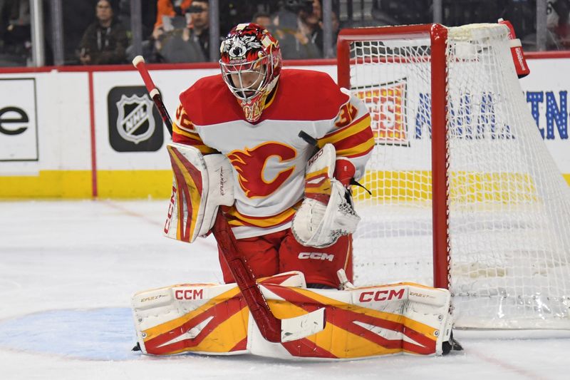 Mar 4, 2025; Philadelphia, Pennsylvania, USA; Calgary Flames goaltender Dustin Wolf (32) makes a save against the Philadelphia Flyers during the third period at Wells Fargo Center. Mandatory Credit: Eric Hartline-Imagn Images