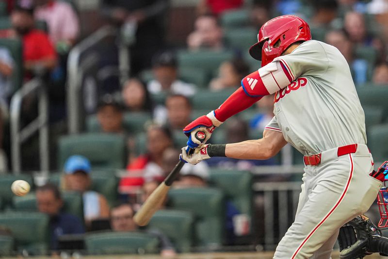 Jul 6, 2024; Cumberland, Georgia, USA; Philadelphia Phillies shortstop Trea Turner (7) singles to drive in a run against the Atlanta Braves during the third inning at Truist Park. Mandatory Credit: Dale Zanine-USA TODAY Sports
