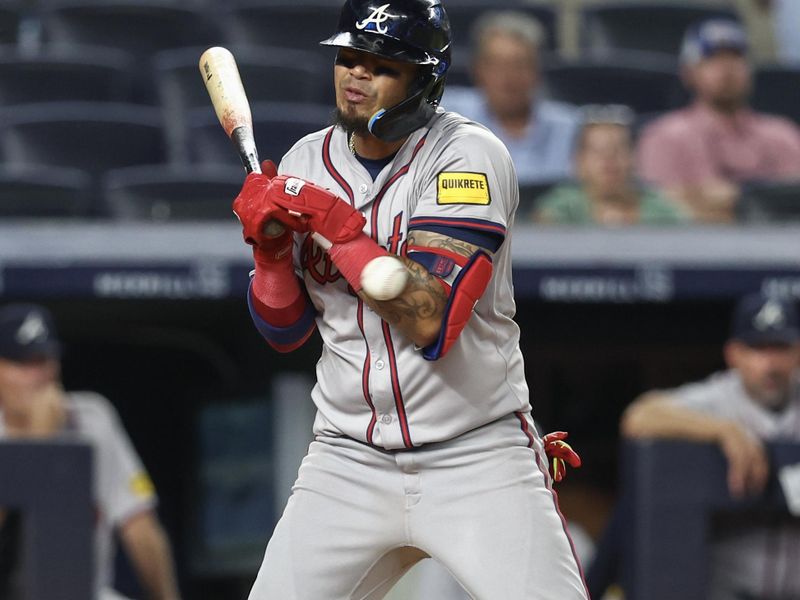 Jun 21, 2024; Bronx, New York, USA; Atlanta Braves shortstop Orlando Arcia (11) gets hit by a pitch in the ninth inning against the New York Yankees at Yankee Stadium. Mandatory Credit: Wendell Cruz-USA TODAY Sports