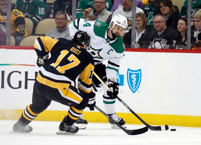 Dec 12, 2022; Pittsburgh, Pennsylvania, USA; Dallas Stars left wing Jamie Benn (14) moves the puck against Pittsburgh Penguins right wing Bryan Rust (17) during the third period at PPG Paints Arena. The Penguins won 2-1. Mandatory Credit: Charles LeClaire-USA TODAY Sports