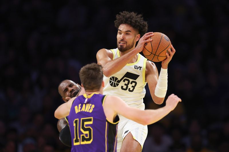 LOS ANGELES, CALIFORNIA - NOVEMBER 19: Johnny Juzang #33 of the Utah Jazz rebounds against LeBron James #23 and Austin Reaves #15 of the Los Angeles Lakers during the second quarter of the Emirates NBA Cup at Crypto.com Arena on November 19, 2024 in Los Angeles, California. NOTE TO USER: User expressly acknowledges and agrees that, by downloading and or using this photograph, User is consenting to the terms and conditions of the Getty Images License Agreement.  (Photo by Harry How/Getty Images)