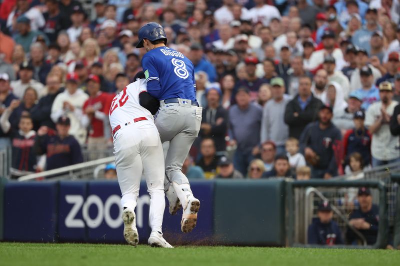 Oct 4, 2023; Minneapolis, Minnesota, USA; Minnesota Twins relief pitcher Griffin Jax (22) tags out Toronto Blue Jays second baseman Cavan Biggio (8) in the eighth inning  during game two of the Wildcard series for the 2023 MLB playoffs at Target Field. Mandatory Credit: Jesse Johnson-USA TODAY Sports