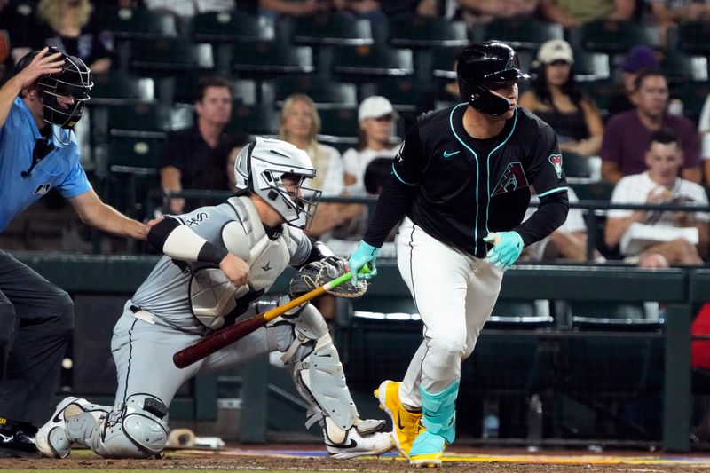 Jun 14, 2024; Phoenix, Arizona, USA; Arizona Diamondbacks designated hitter Joc Pederson (3) hits an RBI fielders choice against the Chicago White Sox in the first inning at Chase Field. Mandatory Credit: Rick Scuteri-USA TODAY Sports