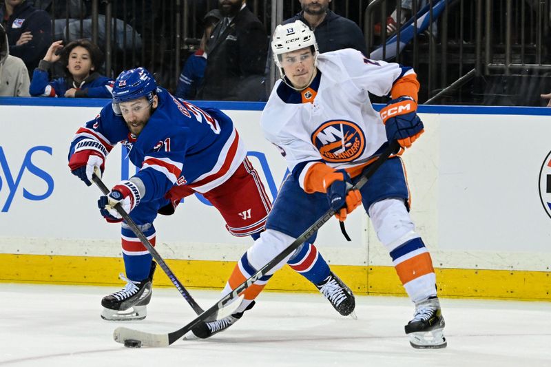 Apr 13, 2024; New York, New York, USA;  New York Islanders center Mathew Barzal (13) controls the puck defended by New York Rangers center Barclay Goodrow (21) during the third period at Madison Square Garden. Mandatory Credit: Dennis Schneidler-USA TODAY Sports