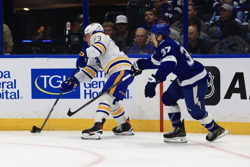 Feb 3, 2026; Tampa, Florida, USA; Tampa Bay Lightning center Yanni Gourde (37) defends Buffalo Sabres defenseman Zach Metsa (73) during the first period at Benchmark International Arena. Mandatory Credit: Kim Klement Neitzel-Imagn Images