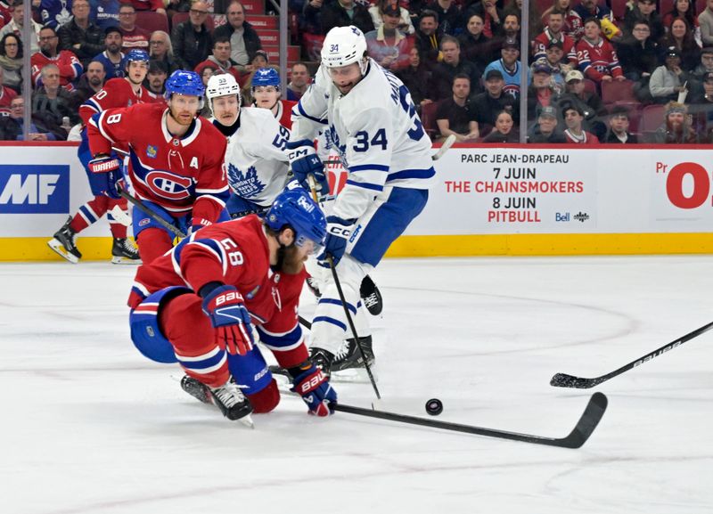 Apr 6, 2024; Montreal, Quebec, CAN; Montreal Canadiens defenseman David Savard (58) stops Toronto Maple Leafs forward Auston Matthews (34) during the first period at the Bell Centre. Mandatory Credit: Eric Bolte-USA TODAY Sports