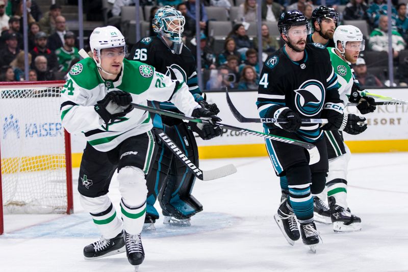 Mar 5, 2024; San Jose, California, USA; Dallas Stars center Roope Hintz (24) and San Jose Sharks defenseman Kyle Burroughs (4) follow the puck during the first period at SAP Center at San Jose. Mandatory Credit: John Hefti-USA TODAY Sports