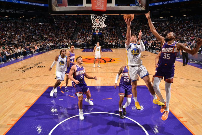 PHOENIX, AZ - NOVEMBER 30: Pat Spencer #61 of the Golden State Warriors drives to the basket during the game against the Phoenix Suns on November 30, 2024 at Footprint Center in Phoenix, Arizona. NOTE TO USER: User expressly acknowledges and agrees that, by downloading and or using this photograph, user is consenting to the terms and conditions of the Getty Images License Agreement. Mandatory Copyright Notice: Copyright 2024 NBAE (Photo by Barry Gossage/NBAE via Getty Images)