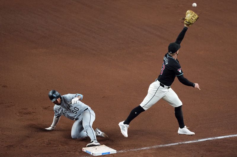 Jun 16, 2024; Phoenix, Arizona, USA; Chicago White Sox third base Lenyn Sosa (50) beats a throw back to Arizona Diamondbacks first base Christian Walker (53) during the seventh inning at Chase Field. Mandatory Credit: Joe Camporeale-USA TODAY Sports