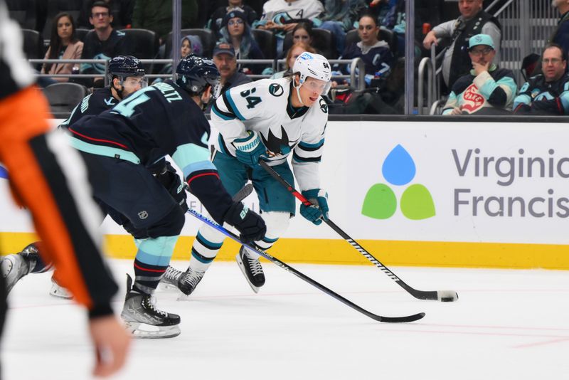 Nov 22, 2023; Seattle, Washington, USA; San Jose Sharks defenseman Jan Rutta (84) advances the puck while defended by Seattle Kraken defenseman Justin Schultz (4) during the third period at Climate Pledge Arena. Mandatory Credit: Steven Bisig-USA TODAY Sports