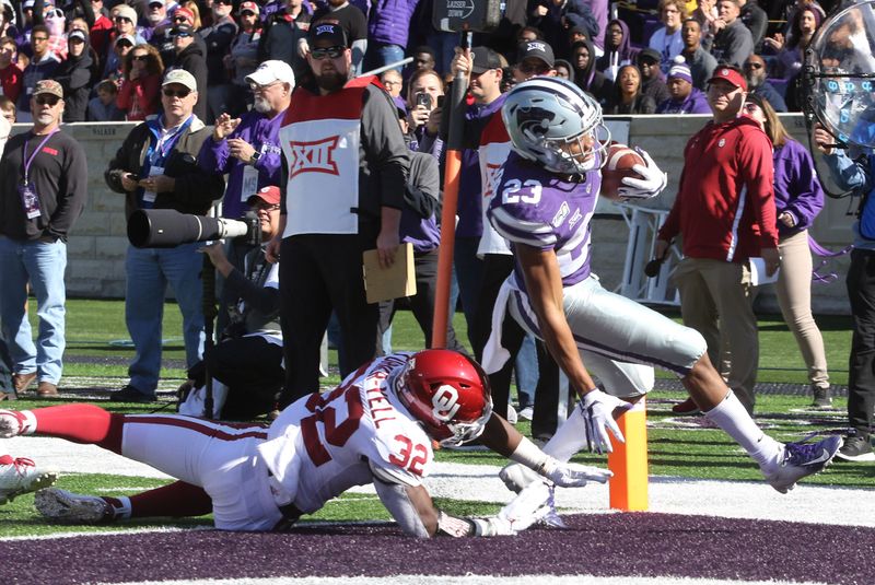 Oct 26, 2019; Manhattan, KS, USA; Kansas State Wildcats wide receiver Wykeen Gill (21) runs past Oklahoma Sooners safety Delarrin Turner-Yell (32) into the end zone for a touchdown in the second quarter of a game at Bill Snyder Family Stadium. Mandatory Credit: Scott Sewell-USA TODAY Sports