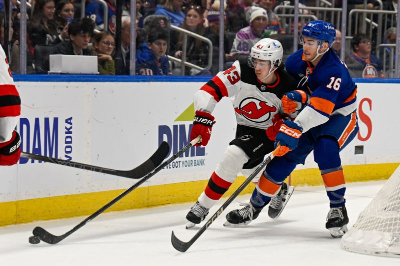 Jan 6, 2026; Elmont, New York, USA; New York Islanders center Marc Gatcomb (16) defends against New Jersey Devils defenseman Luke Hughes (43) during the second period at UBS Arena. Mandatory Credit: Dennis Schneidler-Imagn Images