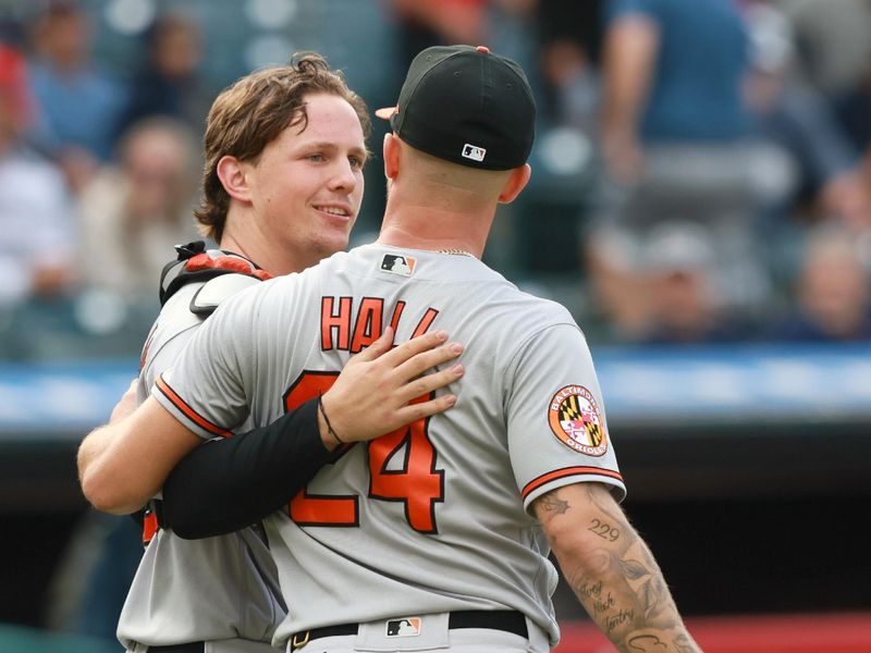 Sep 24, 2023; Cleveland, Ohio, USA; Baltimore Orioles catcher Adley Rutschman (35) congratulates relief pitcher DL Hall (2) after defeating the Cleveland Guardians 5-1 at Progressive Field. Mandatory Credit: Aaron Josefczyk-USA TODAY Sports