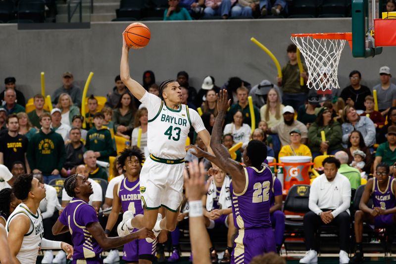Dec 19, 2025; Waco, Texas, USA;  Baylor Bears guard Cameron Carr (43) scores a basket against Alcorn State Braves guard Mike Jones (22) during the first half at Paul and Alejandra Foster Pavilion. Mandatory Credit: Chris Jones-Imagn Images