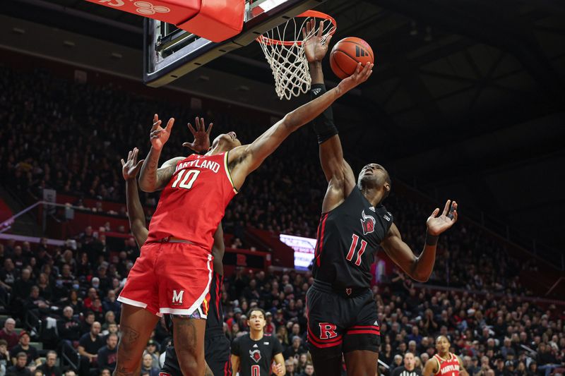 Feb 25, 2024; Piscataway, New Jersey, USA; Maryland Terrapins forward Julian Reese (10) drives for a shot as Rutgers Scarlet Knights center Clifford Omoruyi (11) defends during the first half at Jersey Mike's Arena. Mandatory Credit: Vincent Carchietta-USA TODAY Sports