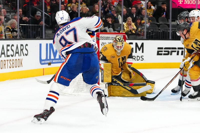 Feb 6, 2024; Las Vegas, Nevada, USA; Edmonton Oilers center Connor McDavid (97) hits the post behind Vegas Golden Knights goaltender Adin Hill (33) during the second period at T-Mobile Arena. Mandatory Credit: Stephen R. Sylvanie-USA TODAY Sports