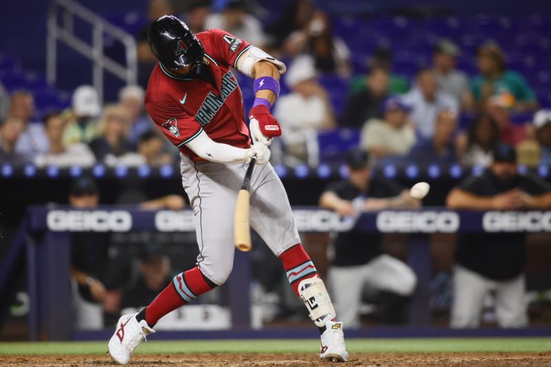 Aug 20, 2024; Miami, Florida, USA; Arizona Diamondbacks left fielder Lourdes Gurriel Jr. (12) hits a solo home run against the Miami Marlins during the sixth inning at loanDepot Park. Mandatory Credit: Sam Navarro-USA TODAY Sports