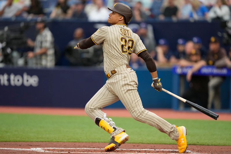 Jul 18, 2023; Toronto, Ontario, CAN;  San Diego Padres left fielder Juan Soto (22) hits a two run home run against the Toronto Blue Jays during the first inning at Rogers Centre. Mandatory Credit: John E. Sokolowski-USA TODAY Sports