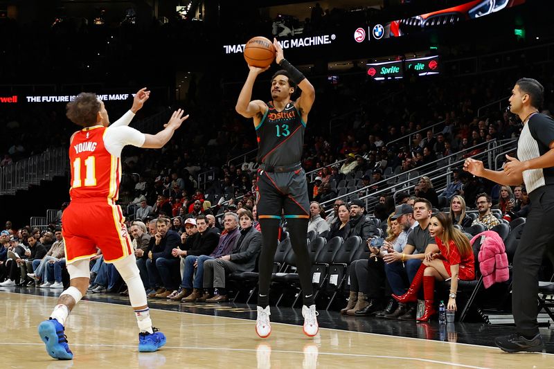 ATLANTA, GA - JANUARY 13: Jordan Poole #13 of the Washington Wizards three point basket during the game Atlanta Hawks on January 13, 2024 at State Farm Arena in Atlanta, Georgia.  NOTE TO USER: User expressly acknowledges and agrees that, by downloading and/or using this Photograph, user is consenting to the terms and conditions of the Getty Images License Agreement. Mandatory Copyright Notice: Copyright 2024 NBAE (Photo by Mercedes Oliver/NBAE via Getty Images)