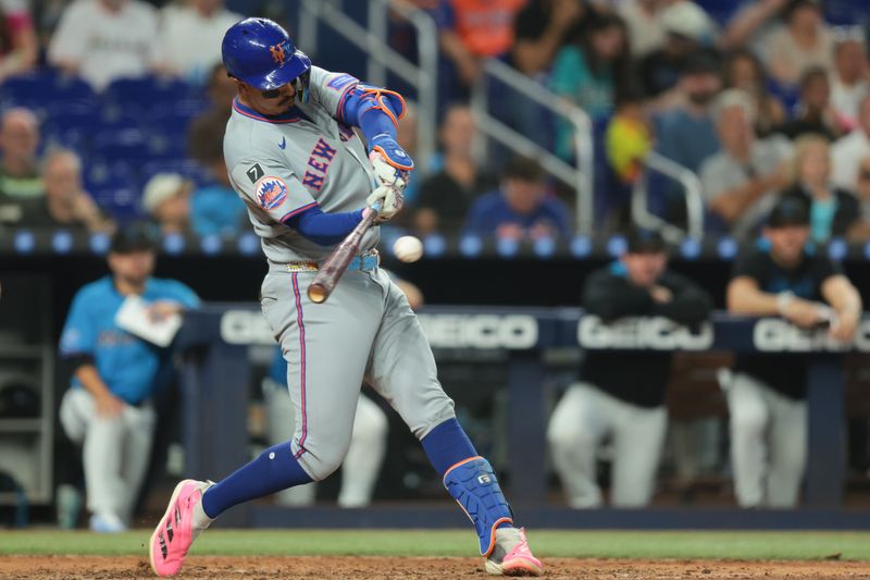 Sep 28, 2025; Miami, Florida, USA; New York Mets designated hitter Mark Vientos (27) hits a single against the Miami Marlins during the sixth inning at loanDepot Park. Mandatory Credit: Sam Navarro-Imagn Images