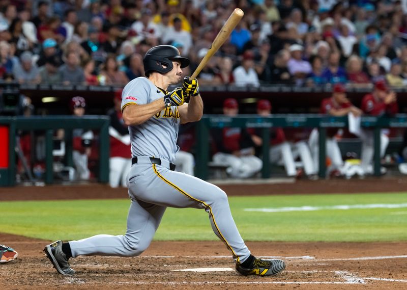 May 28, 2025; Phoenix, Arizona, USA; Pittsburgh Pirates outfielder Bryan Reynolds hits an RBI triple in the sixth inning against the Arizona Diamondbacks at Chase Field. Mandatory Credit: Mark J. Rebilas-Imagn Images