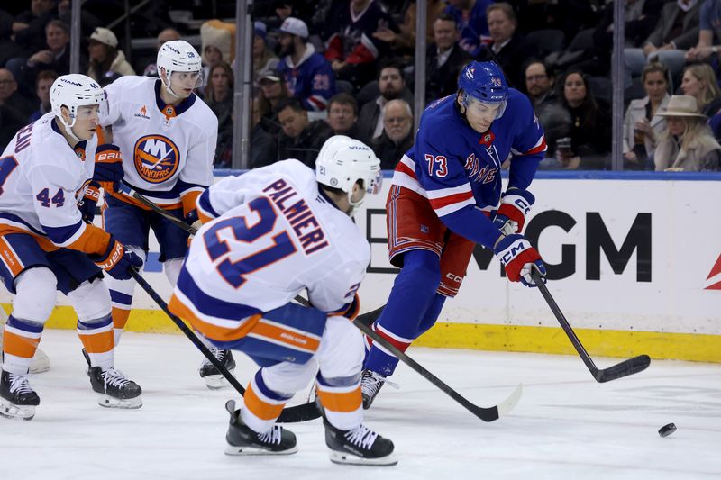 Mar 3, 2025; New York, New York, USA; New York Rangers center Matt Rempe (73) fights for the puck against New York Islanders centers Kyle Palmieri (21) and Jean-Gabriel Pageau (44) and defenseman Alexander Romanov (28) during the third period at Madison Square Garden. Mandatory Credit: Brad Penner-Imagn Images