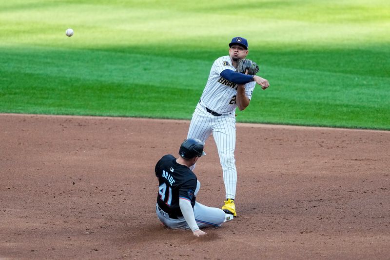 uJul 27, 2024; Milwaukee, Wisconsin, USA;  Milwaukee Brewers shortstop Willy Adames (27) tries to turn a double play as Miami Marlins third baseman Jonah Bride (41) slides into second base during the second inning nat American Family Field. Mandatory Credit: Jeff Hanisch-USA TODAY Sports