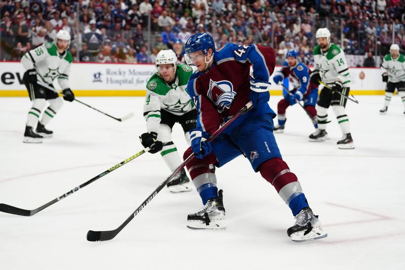 May 17, 2024; Denver, Colorado, USA; Colorado Avalanche defenseman Josh Manson (42) controls the puck in an overtime period against the Dallas Stars in game six of the second round of the 2024 Stanley Cup Playoffs at Ball Arena. Mandatory Credit: Ron Chenoy-USA TODAY Sports