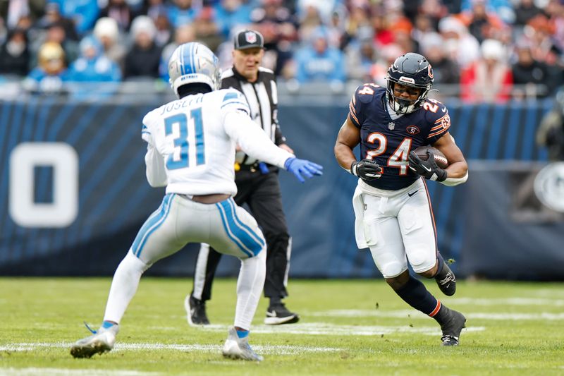 Chicago Bears running back Khalil Herbert (24) runs with the ball against Detroit Lions safety Kerby Joseph (31) during the second half of an NFL football game, Sunday, Dec. 10, 2023, in Chicago. (AP Photo/Kamil Krzaczynski)