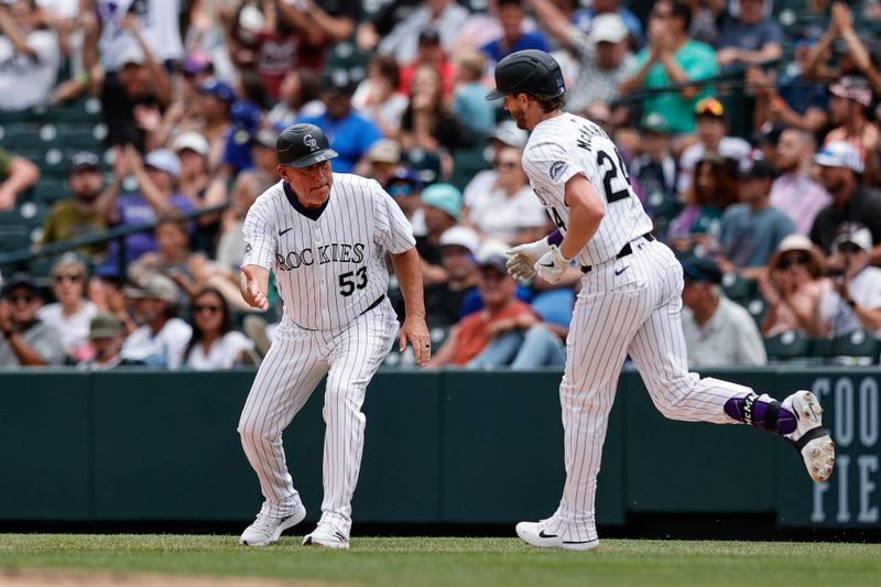 Jun 20, 2024; Denver, Colorado, USA; Colorado Rockies first base coach Ronnie Gideon (53) celebrates the solo home run of third baseman Ryan McMahon (24) in the eighth inning against the Los Angeles Dodgers at Coors Field. Mandatory Credit: Isaiah J. Downing-USA TODAY Sports