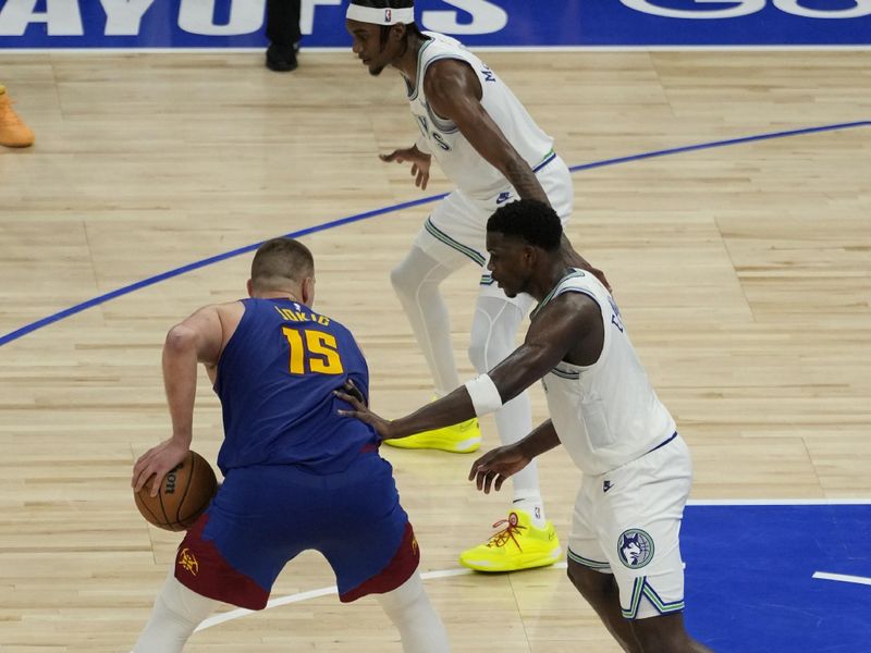 MINNEAPOLIS, MN -  MAY 16: Nikola Jokic #15 of the Denver Nuggets handles the ball against Anthony Edwards #5 of the Minnesota Timberwolves during the game during Round 2 Game 6 of the 2024 NBA Playoffs on May 16, 2024 at Target Center in Minneapolis, Minnesota. NOTE TO USER: User expressly acknowledges and agrees that, by downloading and or using this Photograph, user is consenting to the terms and conditions of the Getty Images License Agreement. Mandatory Copyright Notice: Copyright 2024 NBAE (Photo by Jordan Johnson/NBAE via Getty Images)