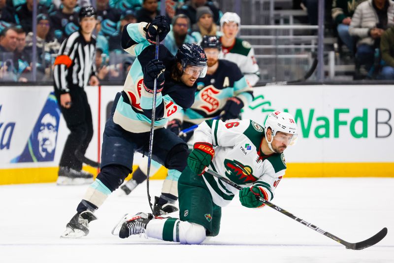 5 =Feb 24, 2024; Seattle, Washington, USA; Seattle Kraken left wing Brandon Tanev (13) pressures Minnesota Wild right wing Mats Zuccarello (36) for the puck as Zuccarello falls to the ice during the first period at Climate Pledge Arena. Mandatory Credit: Joe Nicholson-USA TODAY Sports