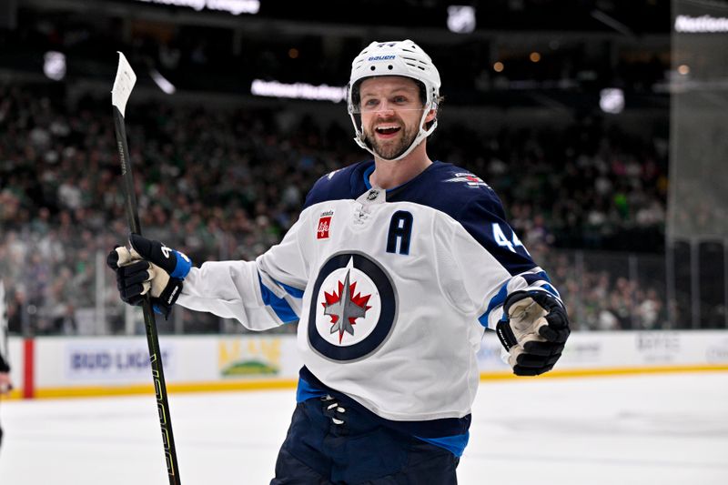 Apr 10, 2025; Dallas, Texas, USA; Winnipeg Jets defenseman Josh Morrissey (44) celebrates a goal scored by right wing Nino Niederreiter (not pictured) against the Dallas Stars during the first period at the American Airlines Center. Mandatory Credit: Jerome Miron-Imagn Images