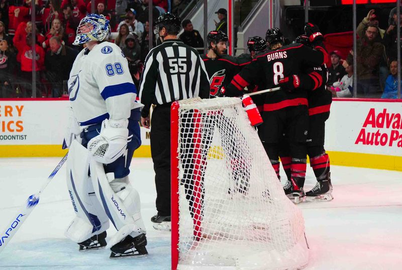 Nov 24, 2023; Raleigh, North Carolina, USA; Carolina Hurricanes right wing Stefan Noesen (23) is congratulated by left wing Michael Bunting (58) center Jack Drury (18)  defenseman Jaccob Slavin (74) and  defenseman Brent Burns (8) after his goal against the Tampa Bay Lightning at PNC Arena. Mandatory Credit: James Guillory-USA TODAY Sports