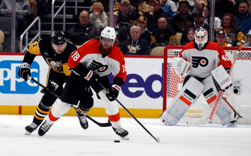 Feb 25, 2024; Pittsburgh, Pennsylvania, USA;  Philadelphia Flyers defenseman Marc Staal (18) skates up ice with the puck as Pittsburgh Penguins center Evgeni Malkin (71) chases during the third period at PPG Paints Arena.  Pittsburgh won 7-6. Mandatory Credit: Charles LeClaire-USA TODAY Sports