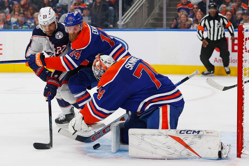 Nov 10, 2025; Edmonton, Alberta, CAN; Columbus Blue Jackets forward Zach Aston-Reese (27) tries to get to a loose puck in front of Edmonton Oilers goaltender Stuart Skinner (74) during the second period at Rogers Place. Mandatory Credit: Perry Nelson-Imagn Images