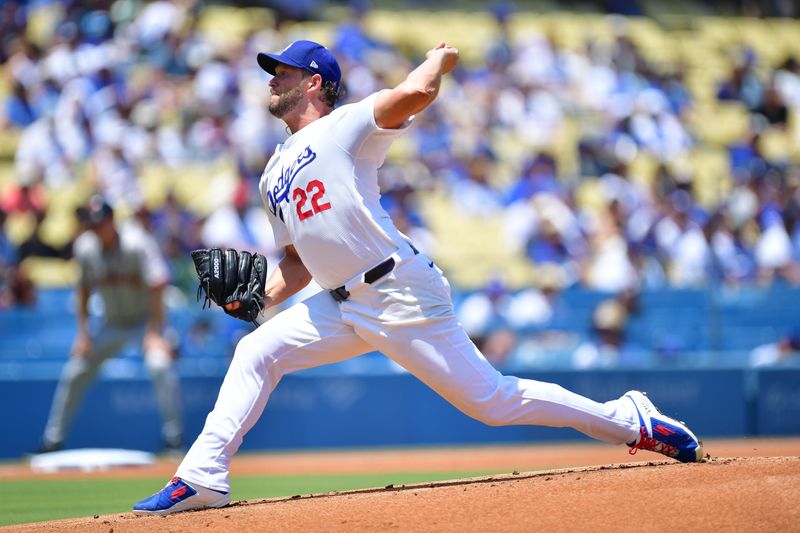 Jul 25, 2024; Los Angeles, California, USA; Los Angeles Dodgers starting pitcher Clayton Kershaw (22) throws against the San Francisco Giants during the first inning at Dodger Stadium. Mandatory Credit: Gary A. Vasquez-USA TODAY Sports