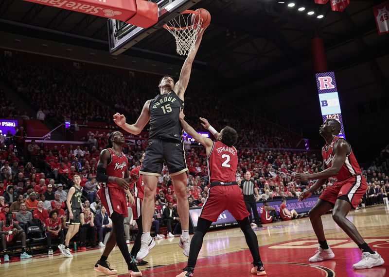 Jan 28, 2024; Piscataway, New Jersey, USA; Purdue Boilermakers center Zach Edey (15) lays the ball in for a basket during the first half in front of Rutgers Scarlet Knights center Clifford Omoruyi (11) and guard Noah Fernandes (2) at Jersey Mike's Arena. Mandatory Credit: Vincent Carchietta-USA TODAY Sports