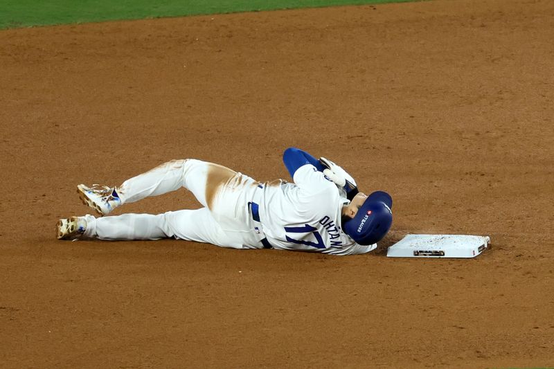 Oct 26, 2024; Los Angeles, California, USA; Los Angeles Dodgers designated hitter Shohei Ohtani (17) reacts after injuring his shoulder against the New York Yankees in the seventh inning for game two of the 2024 MLB World Series at Dodger Stadium. Mandatory Credit: Kiyoshi Mio-Imagn Images