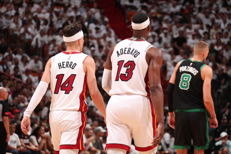 MIAMI, FL - APRIL 27: Bam Adebayo #13 and Tyler Herro #14 of the Miami Heat look on during the game against the Boston Celtics during Round 1 Game 3 of the 2024 NBA Playoffs on April 27, 2024 at Kaseya Center in Miami, Florida. NOTE TO USER: User expressly acknowledges and agrees that, by downloading and or using this Photograph, user is consenting to the terms and conditions of the Getty Images License Agreement. Mandatory Copyright Notice: Copyright 2024 NBAE (Photo by Issac Baldizon/NBAE via Getty Images)