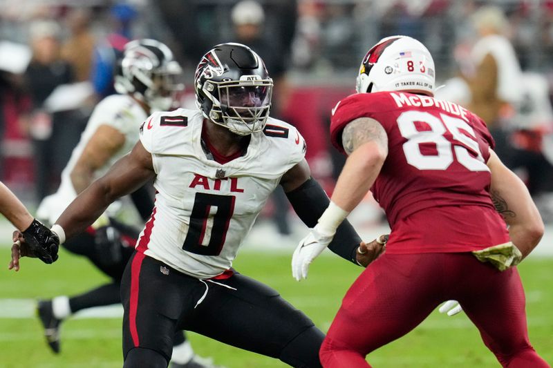 Atlanta Falcons linebacker Lorenzo Carter (0) covers Arizona Cardinals tight end Trey McBride (85) during the second half of an NFL football game Sunday, Nov. 12, 2023, in Glendale, Ariz. The Cardinals won 25-23. (AP Photo/Ross D. Franklin)