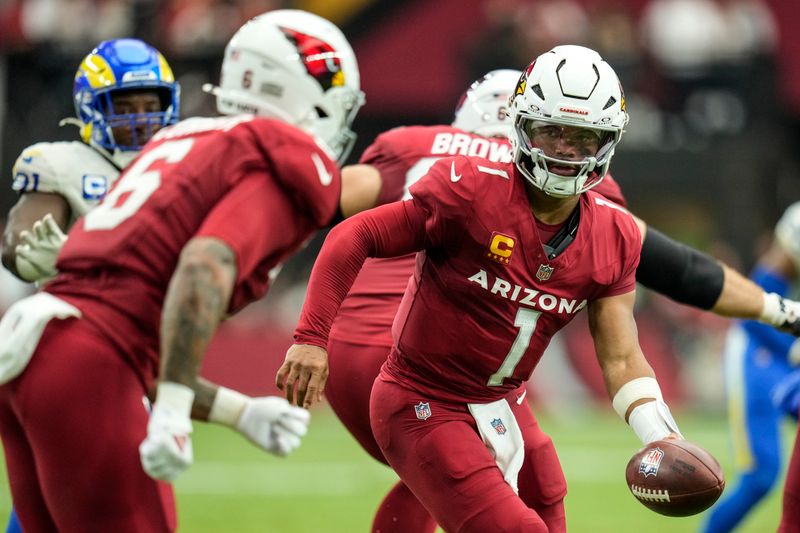 Arizona Cardinals quarterback Kyler Murray (1) prepares to deliver the ball to running back James Conner (6) against the Los Angeles Rams during the first half of an NFL football game, Sunday, Sept. 15, 2024, in Glendale, Ariz. (AP Photo/Ross D. Franklin)