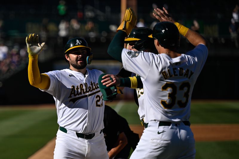 Sep 2, 2024; Oakland, California, USA; Oakland Athletics catcher Shea Langeliers (23) celebrates with outfielder JJ Bleday (33) and outfielder Brent Rooker (25) after hitting a three-run home run against the Seattle Mariners in the third inning at Oakland-Alameda County Coliseum. Mandatory Credit: Eakin Howard-USA TODAY Sports