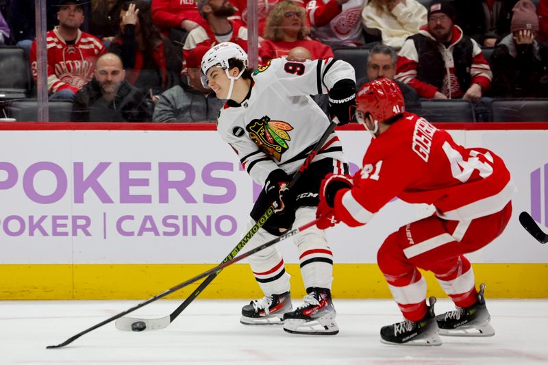 Nov 30, 2023; Detroit, Michigan, USA; Chicago Blackhawks center Connor Bedard (98) skates with the puck defended by Detroit Red Wings defenseman Shayne Gostisbehere (41) in the third period at Little Caesars Arena. Mandatory Credit: Rick Osentoski-USA TODAY Sports