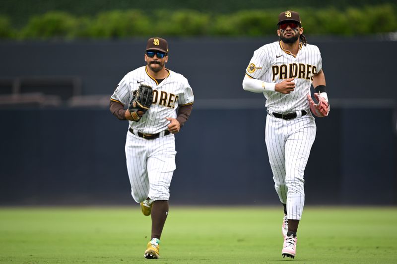 May 17, 2023; San Diego, California, USA; San Diego Padres center fielder Trent Grisham (left) and right fielder Fernando Tatis Jr. (right) run off the field during the fifth inning against the Kansas City Royals at Petco Park. Mandatory Credit: Orlando Ramirez-USA TODAY Sports