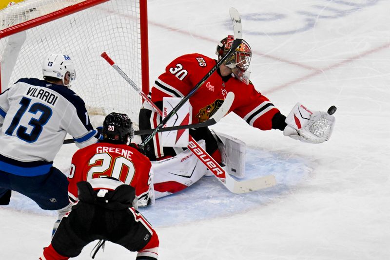 Jan 19, 2026; Chicago, Illinois, USA;  Chicago Blackhawks goaltender Spencer Knight (30) makes a save against the Winnipeg Jets during the second period at United Center. Mandatory Credit: Matt Marton-Imagn Images
