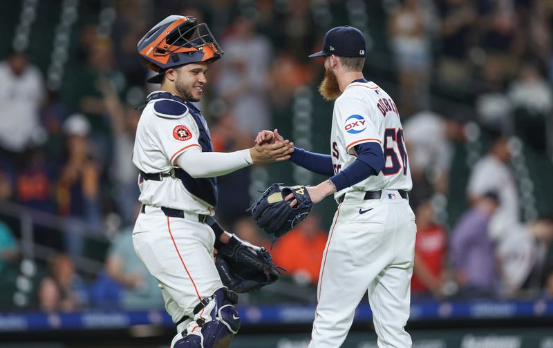 May 16, 2024; Houston, Texas, USA; Houston Astros relief pitcher Shawn Dubin (66) celebrates with catcher Yainer Diaz (21) after the final out against the Oakland Athletics at Minute Maid Park. Mandatory Credit: Troy Taormina-USA TODAY Sports