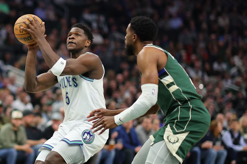 MILWAUKEE, WISCONSIN - FEBRUARY 08: Anthony Edwards #5 of the Minnesota Timberwolves drives to the basket against Malik Beasley #5 of the Milwaukee Bucks during the first half of a game at Fiserv Forum on February 08, 2024 in Milwaukee, Wisconsin. NOTE TO USER: User expressly acknowledges and agrees that, by downloading and or using this photograph, User is consenting to the terms and conditions of the Getty Images License Agreement. (Photo by Stacy Revere/Getty Images)