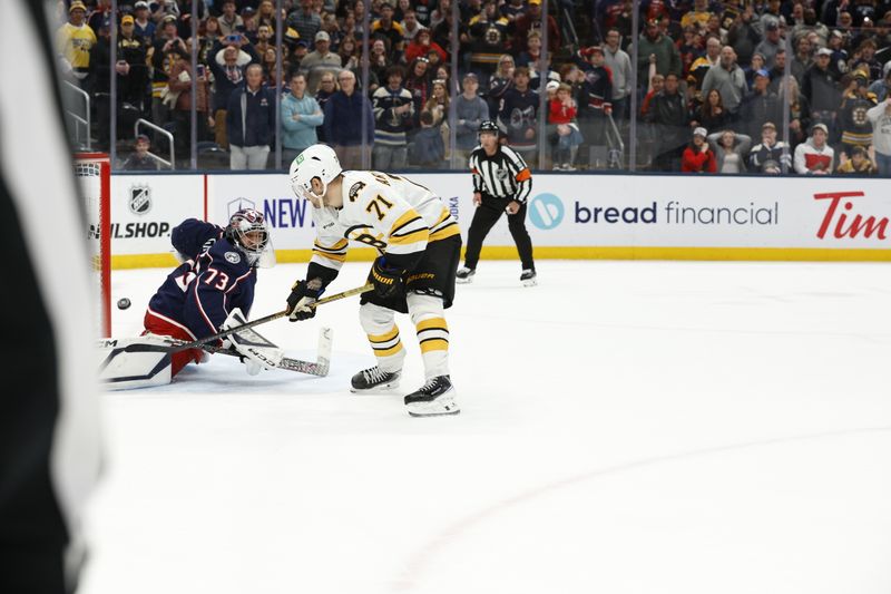 Mar 29, 2026; Columbus, Ohio, USA; Boston Bruins left wing Viktor Arvidsson (71) scores the game winner over Columbus Blue Jackets goalie Jet Greaves (73) during the shootout at Nationwide Arena. Mandatory Credit: Russell LaBounty-Imagn Images