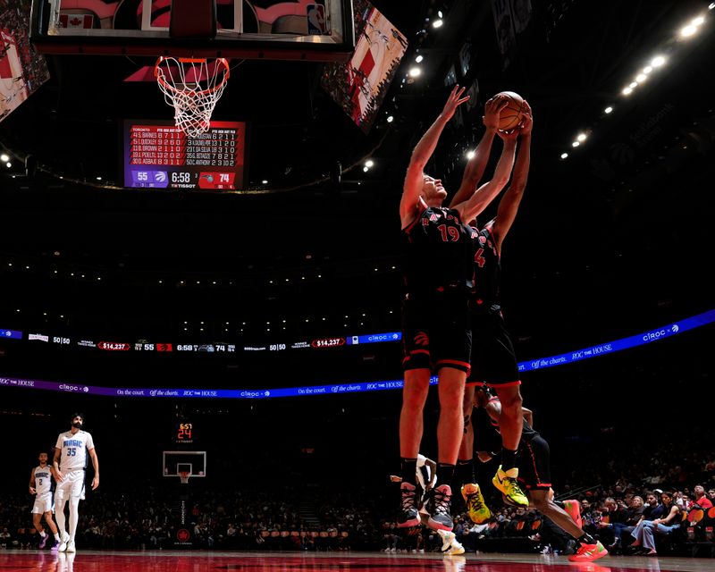 TORONTO, CANADA - JANUARY 3: Jakob Poeltl #19 of the Toronto Raptors rebounds during the game against the Orlando Magic on January 3, 2025 at the Scotiabank Arena in Toronto, Ontario, Canada.  NOTE TO USER: User expressly acknowledges and agrees that, by downloading and or using this Photograph, user is consenting to the terms and conditions of the Getty Images License Agreement.  Mandatory Copyright Notice: Copyright 2025 NBAE(Photo by Mark Blinch/NBAE via Getty Images)